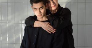 A tender moment captured between a mother and her adult son in natural sunlight.