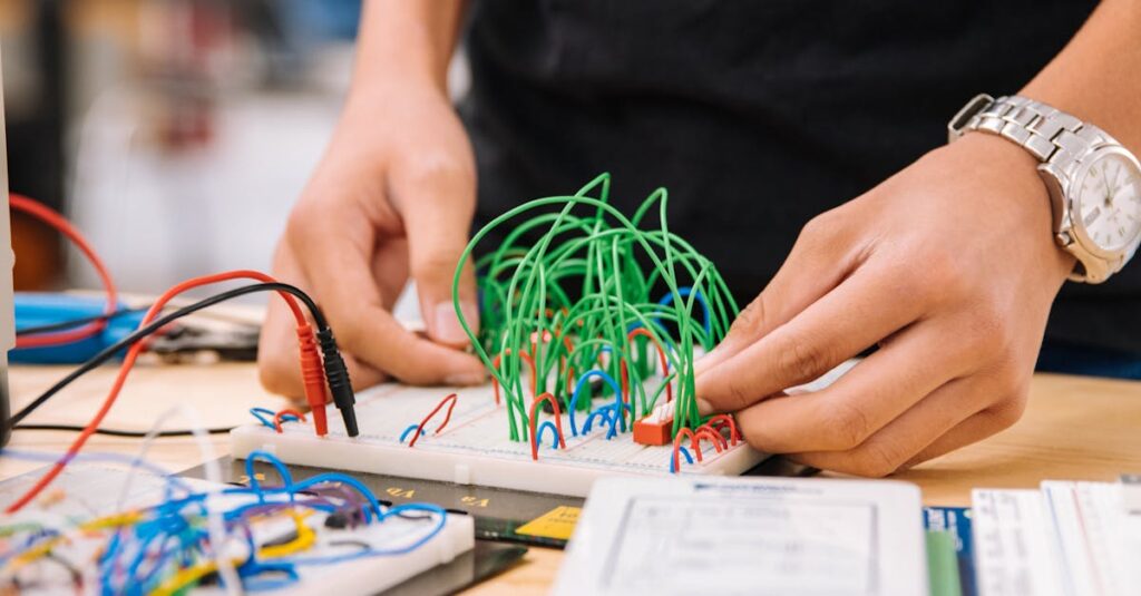 Εκπαίδευση και κοινωνική επανένταξη 5 Hands manipulating wires on breadboards for electronic prototyping.